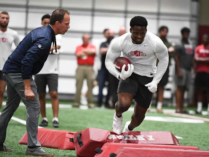 Mar 30, 2022; Tuscaloosa, AL, USA; Mike Sharilli from the Denver Broncos conducts a drill for Alabama running back Brian Robinson Jr. (4) at Hank Crisp Indoor Facility.